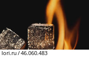 Melting ice cubes against dynamic flames in slowmotion sequence. Стоковое AI-видео, аниматор Zakharova Natasha / Фотобанк Лори
