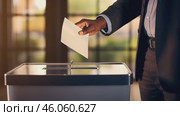 Hand of a person casting a vote into the ballot box during elections. Стоковое AI-видео, аниматор Ирина Старикова / Фотобанк Лори