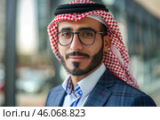 Portrait of an arab businessman wearing a keffiyeh and suit in a modern office environment. Стоковое AI-изображение, AI-художник Иван Рябоконь / Фотобанк Лори
