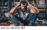 Male electrician working in switchboard with electrical connecting cable. Work in repair shops and maintenance services. Stress, nerves. Стоковое видео, видеограф ALLA YURTAYEVA / Фотобанк Лори