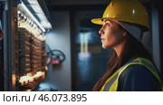 Female electrician working in switchboard with electrical connecting cable. Work in repair shops and maintenance services. Stress, nerves. Стоковое видео, видеограф ALLA YURTAYEVA / Фотобанк Лори