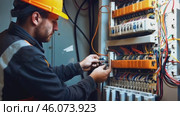 Male electrician working in switchboard with electrical connecting cable. Work in repair shops and maintenance services. Stress, nerves. Стоковое видео, видеограф ALLA YURTAYEVA / Фотобанк Лори