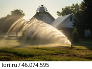 Water sprinkler irrigating grass field at sunrise near farm buildings. Стоковое AI-изображение, AI-художник Иван Рябоконь / Фотобанк Лори