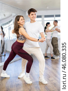 Girl paired up with young man, they train to perform slow waltz dance, rehearse performance. Стоковое фото, фотограф Яков Филимонов / Фотобанк Лори