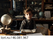 Young historian exploring the past in his vintage study room. Стоковое AI-изображение, AI-художник Иван Рябоконь / Фотобанк Лори