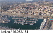View from drone of El Masnou beach and sea port with boats at Catalonia, Spain. Стоковое видео, видеограф Яков Филимонов / Фотобанк Лори