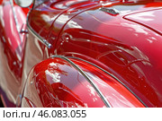 Shiny red vintage car reflecting the sky. Стоковое AI-изображение, AI-художник Иван Рябоконь / Фотобанк Лори