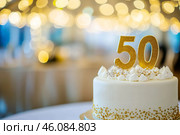 50th birthday cake adorned a gold accents. Birthday party. Blurred light festive background. Golden balloons. Fifty years, Fiftieth anniversary. Celebration cake, golden candles. Numbers 50. Стоковое AI-изображение, AI-художник Марина Демидюк / Фотобанк Лори
