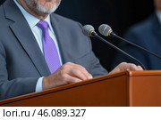 Close-up of a speaker making a speech at a conference. Стоковое AI-изображение, AI-художник Евгений Харитонов / Фотобанк Лори