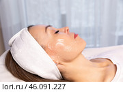Woman on a couch with gel on her face before beauty treatment, removing pigmentation at cosmetic clinic. Phototherapy, photorejuvenation, IPL in a beauty salon. Skin care concept. High quality photo. Стоковое фото, фотограф Ирина Михайличенко / Фотобанк Лори