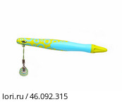 Green ball pen with a pendant isolated on a white background. Стоковое фото, фотограф Елена  Попкова / Фотобанк Лори