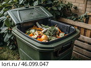 An open compost container with peels and fruit and vegetable clippings. Organic waste in a garden composter. Eco-friendly gardening, sustainability, ecology. Стоковое AI-изображение, AI-художник Photojuli / Фотобанк Лори