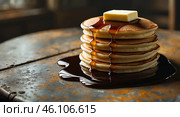 Stack of fluffy pancakes drizzled with syrup and topped with a pat of butter on a rustic table. Стоковое AI-изображение, AI-художник Сергей Толмачёв / Фотобанк Лори