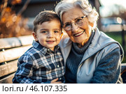 A happy family, a child and a grandmother hug on the street in the park, happy and contented. A grandmother who hugs her grandson, showing love. Стоковое AI-изображение, AI-художник Photojuli / Фотобанк Лори