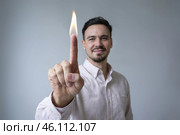 Man raised his finger with a flame on the end. Focus on the finger. Стоковое AI-изображение, AI-художник Дмитрий Киселёв / Фотобанк Лори