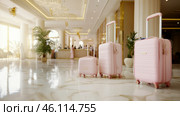 Travel bags in modern hotel lobby with blurred receptionists. Стоковое AI-изображение, AI-художник Анастасия Золотницкая / Фотобанк Лори