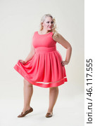 Plus size fashion model, fat woman on beige background, overweight female body. Стоковое фото, фотограф Станислав Тарко / Фотобанк Лори