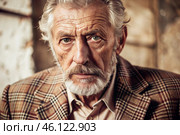 Studio portrait of a stylish, elegant elderly man, 70 years old, in a checkered jacket in brown tones. The concept of the elderly. Стоковое AI-изображение, AI-художник Photojuli / Фотобанк Лори