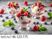 Sweet dessert. The love of ice cream. Vanilla ice cream balls and fresh strawberries, raspberries, and blueberries. Banner, advertisement. Стоковое AI-изображение, AI-художник Photojuli / Фотобанк Лори