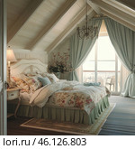 A cozy bedroom in the Provence style, located in the attic. The interior is filled with light pastel shades, and the wooden beams on the ceiling create an atmosphere of coziness and warmth. In the center of the room is a large bed with a carved headboard, decorated with floral bed linen, decorative pillows and a blanket. On the bedside table there is an elegant lamp with soft light. The space is complemented by a vintage-style chandelier, and large windows with luxurious curtains let in a lot of natural light. Through the window you can see a terrace with wicker furniture, which adds to the feeling of a country holiday. Стоковое AI-изображение, AI-художник Анна Кривицкая / Фотобанк Лори