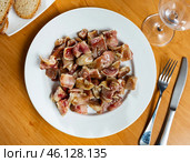 Pieces of pickled and boiled pork ears perfectly complement glass of dark beer. Стоковое фото, фотограф Яков Филимонов / Фотобанк Лори