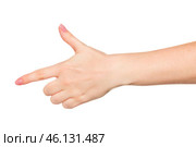 Hand gesture mimicking a gun takes center stage in a light setting during a creative exploration of body language. Стоковое фото, фотограф Сергей Толмачёв / Фотобанк Лори