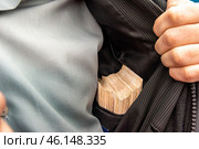 a bundle of bills in an inner pocket. Стоковое фото, фотограф Дмитрий Коростылев / Фотобанк Лори