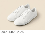 White leather lace-up running shoes with low tops, thick soles on a beige. The laces and rubber outsole. Sporty look. Men to wear during outdoor activities. Street hiking shoes. Trendy Male Boots Pair. Стоковое AI-изображение, AI-художник Марина Демидюк / Фотобанк Лори