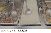 Three trays with food and cutlery. The trays are filled with rice, buckwheat porridge and other products. close-up. Стоковое видео, видеограф Скрипачев Антон / Фотобанк Лори