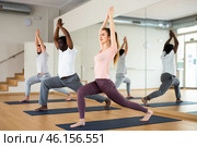Woman standing in Ashta Chandrasana with hands in namaste over head. Стоковое фото, фотограф Яков Филимонов / Фотобанк Лори