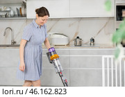 Housewife does cleaning in room - vacuums and dusts. Стоковое фото, фотограф Яков Филимонов / Фотобанк Лори