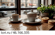 A white cup of hot coffee and biscuits on a table in a modern cozy cafe by the window. It's raining outside. The concept of comfort and warmth. Стоковое AI-изображение, AI-художник Photojuli / Фотобанк Лори