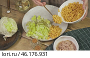Grains of bright yellow, ripe corn are a vital component of a delightful, low-calorie, and nutritious French salad. Стоковое видео, видеограф Strunov David / Фотобанк Лори