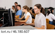 Focused female teenager solving tasks of computer science in the auditory. Стоковое фото, фотограф Яков Филимонов / Фотобанк Лори