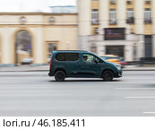 Citroen Berlingo 2023 model LCV rides on the city road. Pale blue delivery van in motion. Редакционное фото, фотограф Константин Григорьев / Фотобанк Лори