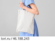 Woman with eco bag on light background. Стоковое фото, фотограф Pixel_shot / Фотобанк Лори