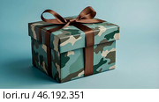 The concept of Defender of the Fatherland Day on February 23. Gift camouflage box with a festive satin ribbon bow on a light blue background. Стоковое AI-изображение, AI-художник Photojuli / Фотобанк Лори