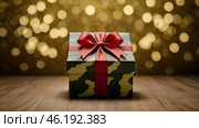 The concept of Defender of the Fatherland Day on February 23. Gift camouflage box with a festive satin ribbon bow on a gold background. Стоковое AI-изображение, AI-художник Photojuli / Фотобанк Лори