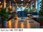 Modern open-plan office. In the center of the frame, an iMac with an open code editor sits on a wooden table, indicating that a programmer is working. The office is filled with green potted plants, giving the interior a cozy atmosphere. The lighting is warm, with many lamps creating a soft glow. In the background, other workstations with computers are visible, but without people, creating a feeling of silence and productivity. A spacious, well-organized coworking center or IT office with a minimalist design and biophilic elements. Стоковое AI-изображение, AI-художник Анна Кривицкая / Фотобанк Лори