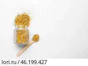 Jar and spoon with bee pollen on light background. Стоковое фото, фотограф Pixel_shot / Фотобанк Лори