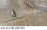 Construction site with a large truck and a smaller truck. Стоковое видео, видеограф Скрипачев Антон / Фотобанк Лори