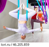 Woman doing inverted bound angle pose in hanging hammock with fingers in mudra. Стоковое фото, фотограф Яков Филимонов / Фотобанк Лори