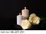 Burning candles, mourning ribbon and flowers on black background. Стоковое фото, фотограф Pixel_shot / Фотобанк Лори