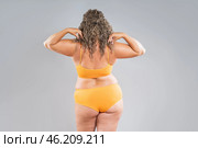 Overweight thigh, woman with fat hips, back and buttocks, obesity female body with cellulite on gray background. Стоковое фото, фотограф Станислав Тарко / Фотобанк Лори