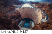Majestic view of a massive concrete dam in a desert canyon. Стоковое AI-изображение, AI-художник Екатерина Усенко / Фотобанк Лори
