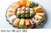 Colorful wagashi selection arranged on elegant glass platter, celebrating japanese confectionery. Стоковое AI-изображение, AI-художник Юрий Поздников / Фотобанк Лори