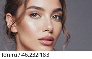 Portrait of caucasian young woman with clean smooth skin. Cute girl on gray background. Beauty female model. Woman in studio. Facial skin care and beautiful natural makeup. Стоковое AI-видео, аниматор Ирина / Фотобанк Лори