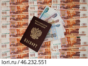 Денежный фон из пятитысячных купюр, купюры 50, 100, 500 и 1000 рублей, российский паспорт / A monetary fund of five thousand banknotes, 50, 100, 500 and 1000 rubles, a Russian passport. Стоковое фото, фотограф Петроченко Мария Петровна / Фотобанк Лори