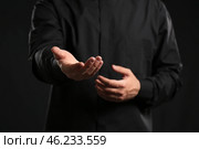 Handsome young priest on dark background, closeup. Стоковое фото, фотограф Pixel_shot / Фотобанк Лори