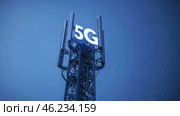 5G cell tower illuminated against a clear blue sky during evening hours. Стоковое AI-изображение, AI-художник Александр Довянский / Фотобанк Лори